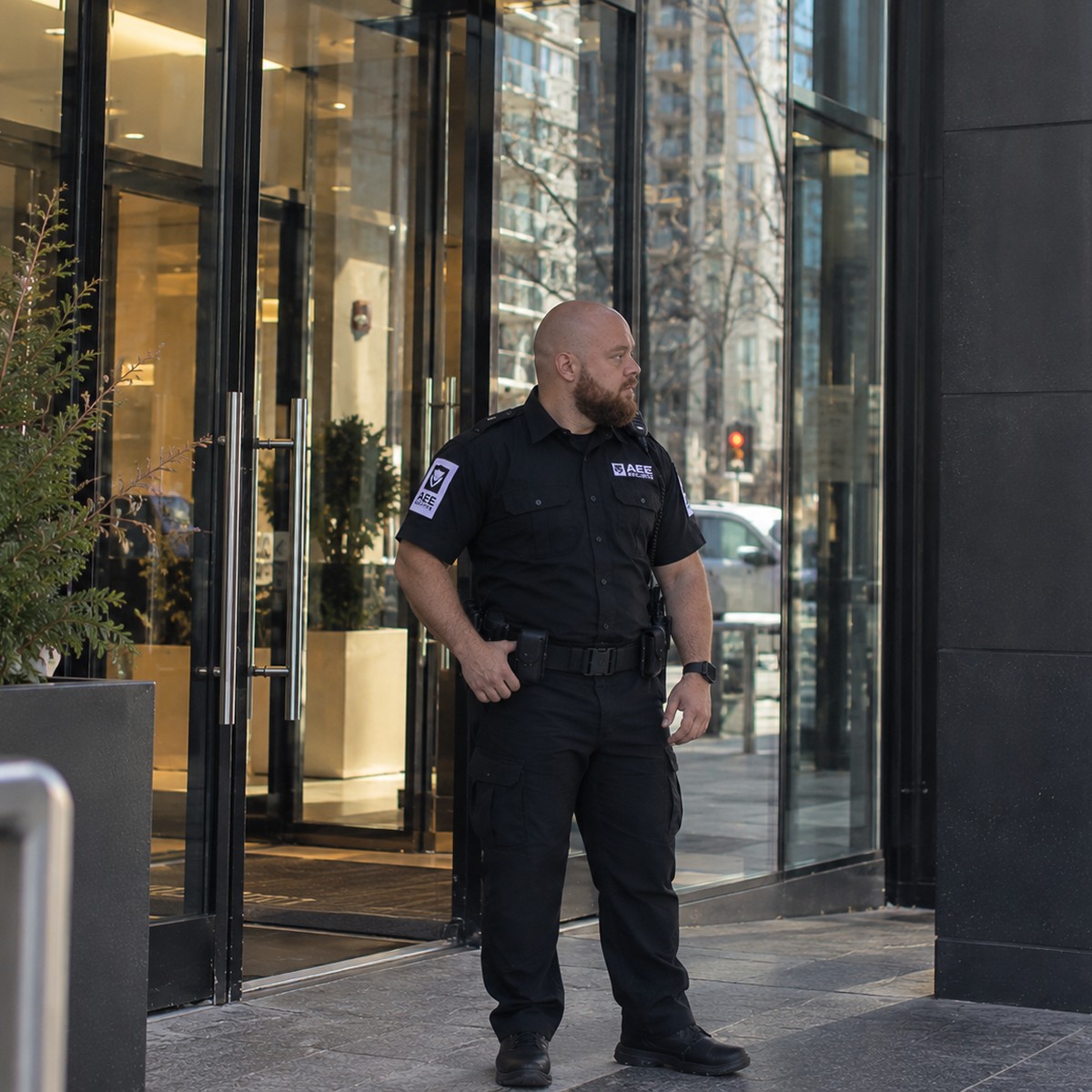 Agent de sécurité AEE en faction devant un immeuble